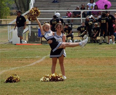 Image: The IYAA A-Team cheerleaders stick their halftime performance as Caroline Pittman displays cheermate Taylor Boyd.