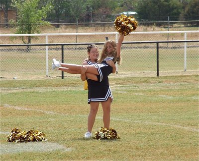 Image: Carlee Wafer hoists Caitlin Oldfield to conclude the IYAA A-Team cheerleaders’ halftime performance.