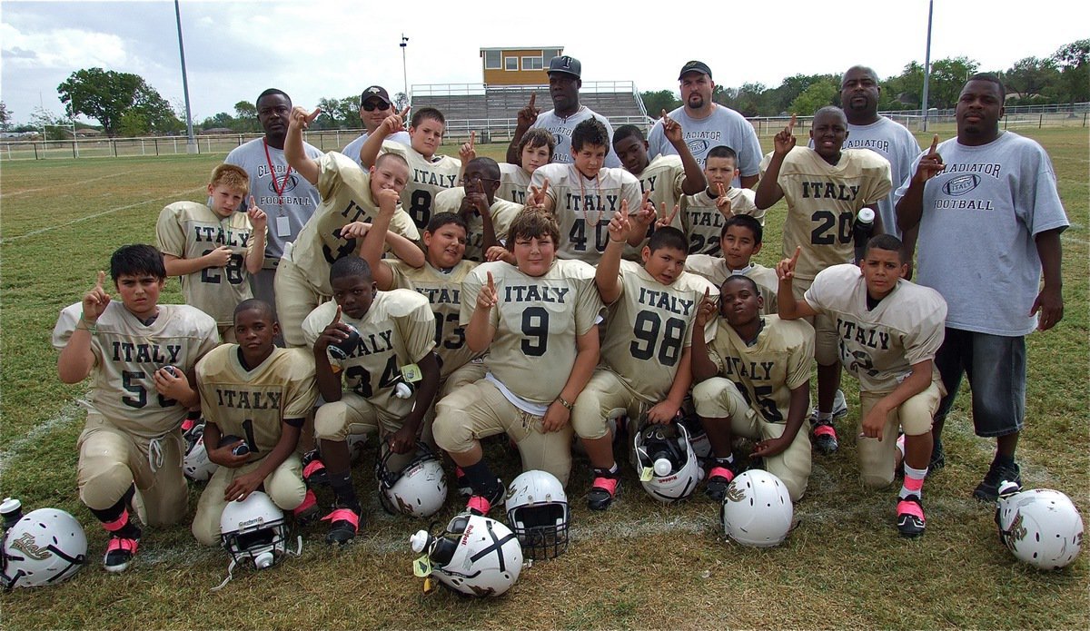 Image: The IYAA A-Team (4-0) poses for a team picture after their 32-6 Homecoming win over the Hubbard Jaguars.