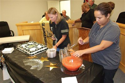 Image: City of Italy employees Becky Boyd and Clarice Short serve cake and punch to those attending the event.
