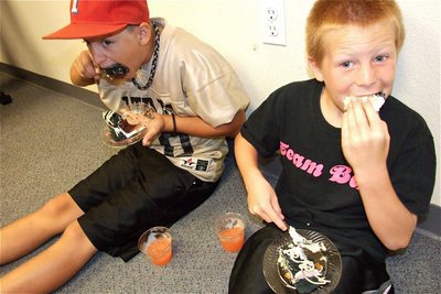 Image: IYAA student athletes Gary Wood and Ty Cash waste no time enjoying the desserts of their labor.