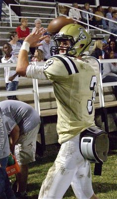 Image: Gladiator quarterback Jase Holden(3) stays ready on the sideline.