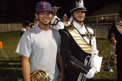 Image: Alumni Taz Martinez (’11) assists the band while spending time with cousin Reid Jacinto.
