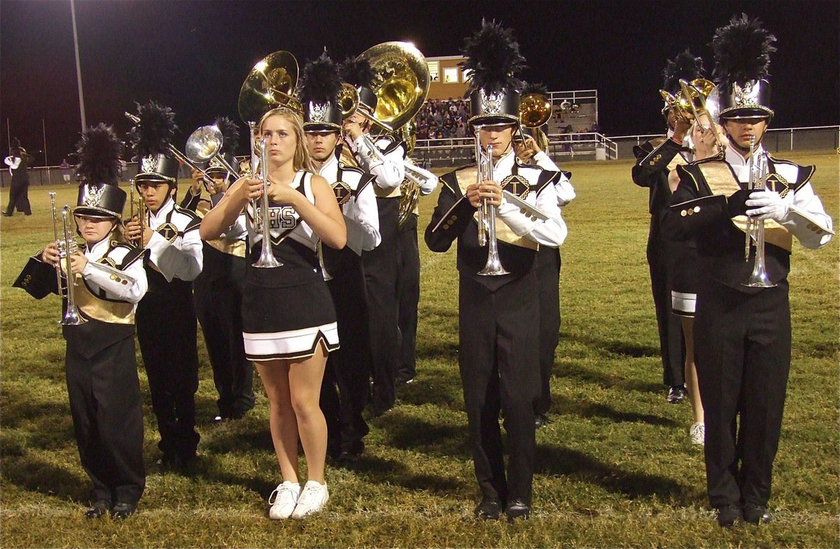 Image: A section of the Gladiator Regiment Marching Band come to a temporary halt, get their picture taken and then continue on with the halftime show.