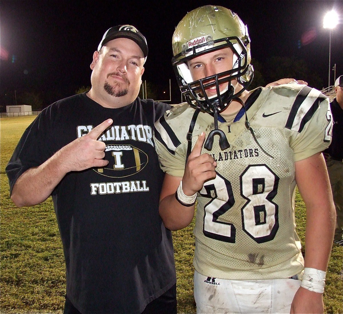 Image: Kyle Jackson(28) and his father, Bubba Jackson, celebrate the team’s win over Buffalo.