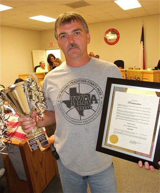 Image: Congratulations to IYAA President Gary Wood who displays the “IYAA Volunteer of the Year” trophy, with his name engraved on it, and the IYAA Day Proclamation plaque.