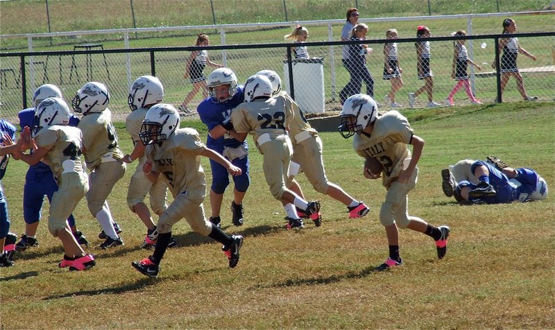 Image: Eric Martinez(5) leads the way for Parker Richters(12) to setup a B-Team Gladiator touchdown.