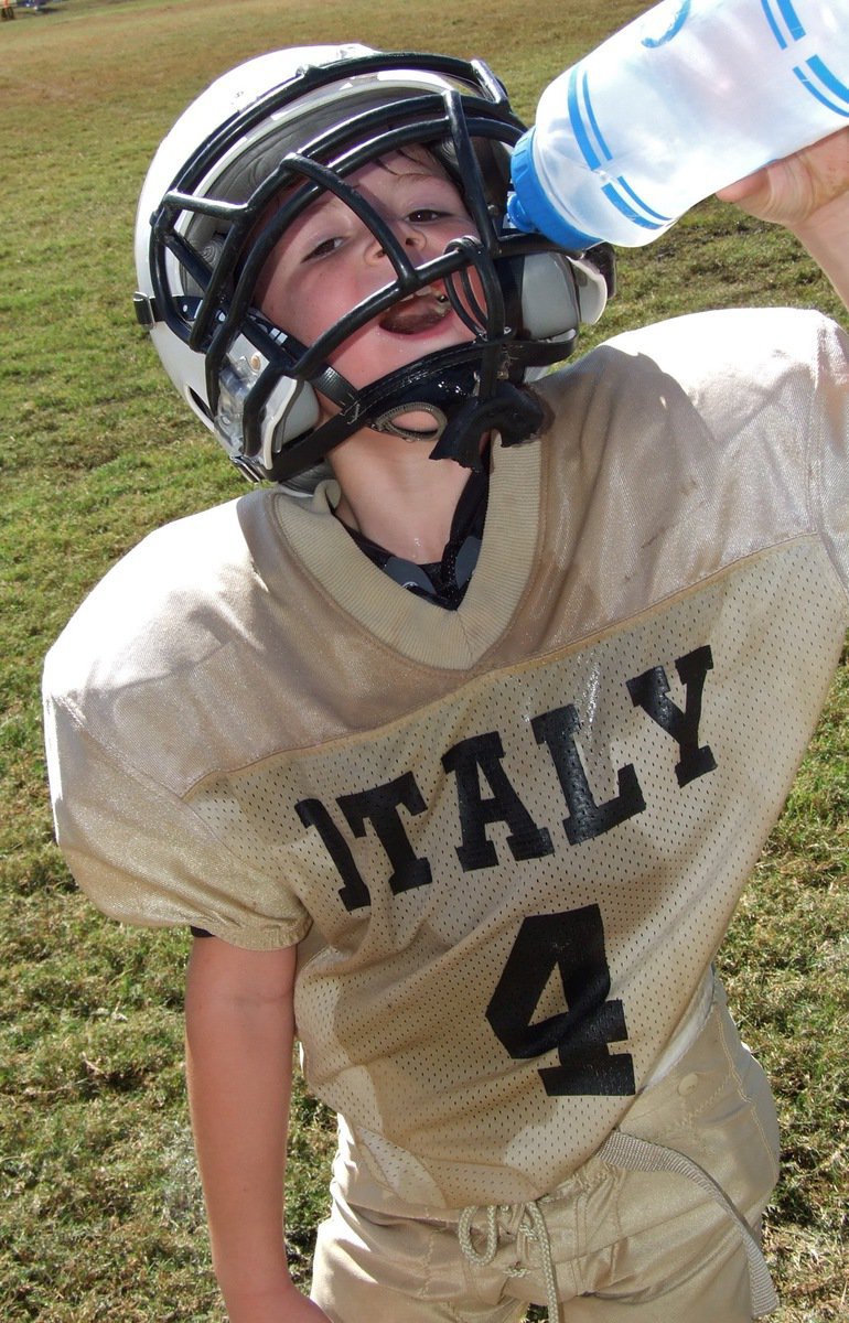 Image: B-Team Gladiator Bryce DeBorde(4) rehydrates his smile.