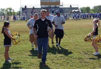 Image: Happy B-Team coaches, Gary Wood, Roy Stephens, Andy Saxon and Jasenio Anderson take a victory lap down spirit lane.