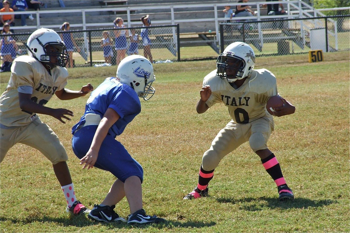 Image: Adam Powell(25) tries to clear space for Kendrick Norwood(10) as he attempts to juke a Lion defender.