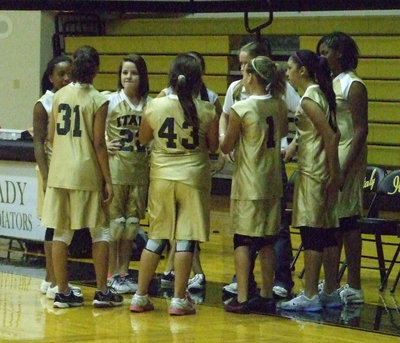 Image: 7th grade team huddled up with Coach Reeves.