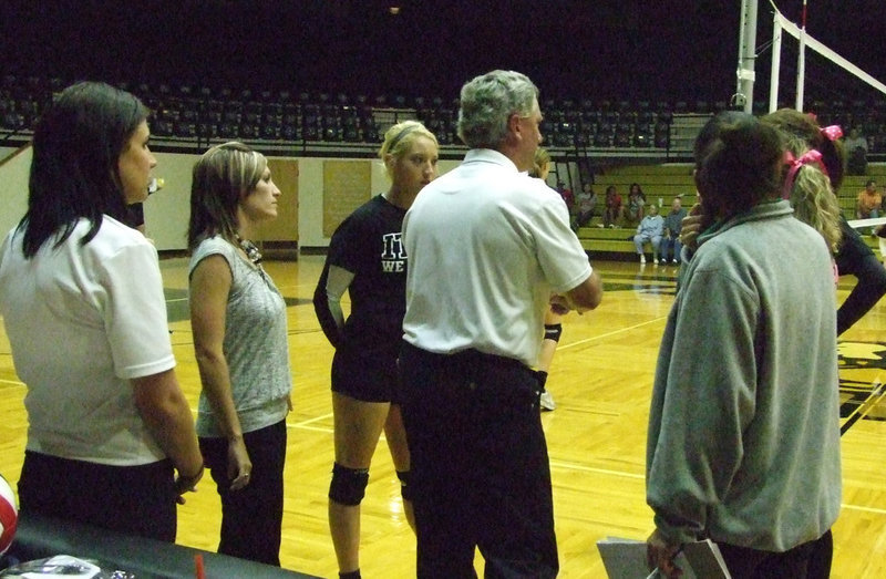 Image: Co-captain Megan Richards meets with the referee and coaches to review the rules.  The Lady Gladiators hosted the Lady Eagles from Rio Vista this week.