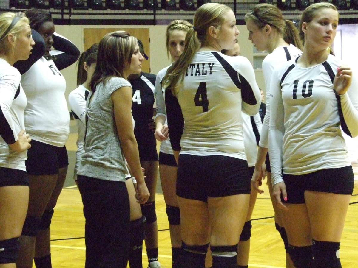 Image: The Lady Gladiators and Coach Richters check the score.