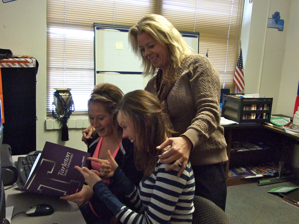 Image: New Italy High School counselor, Sharon Davis, helps Bailey Bumpus and Kaitlyn Rossa with choices in their future education.