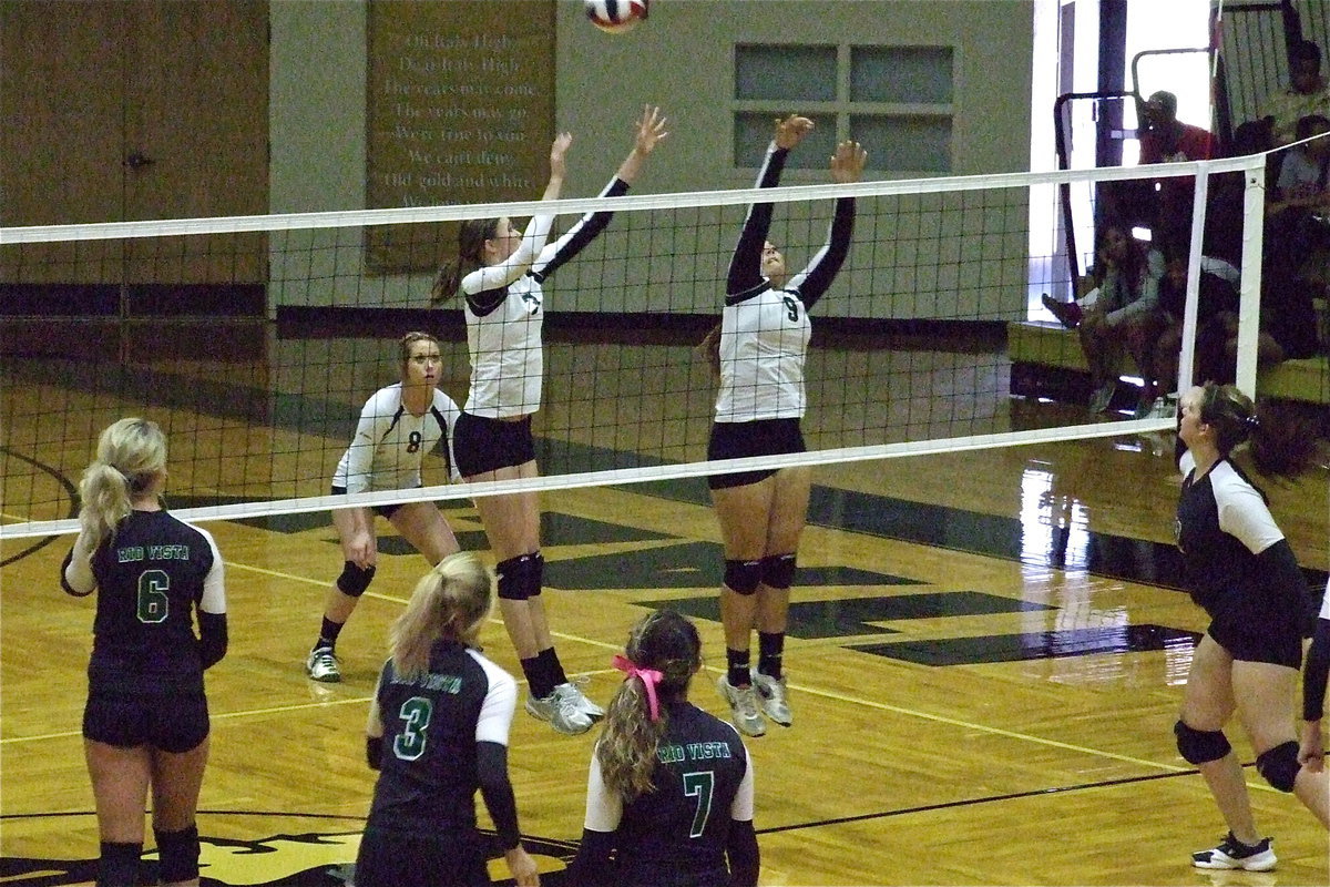 Image: Bailey Bumpus(8) backs up Kaitlyn Rossa(3) and Alyssa Richards(9) with Richards getting a piece of the ball.