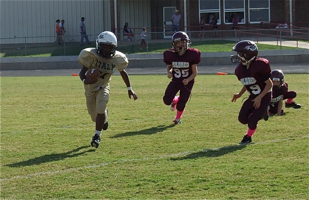 Image: Ricky Pendleton(21) eludes Mildred defenders on his way to a big gain for the IYAA B-Team.