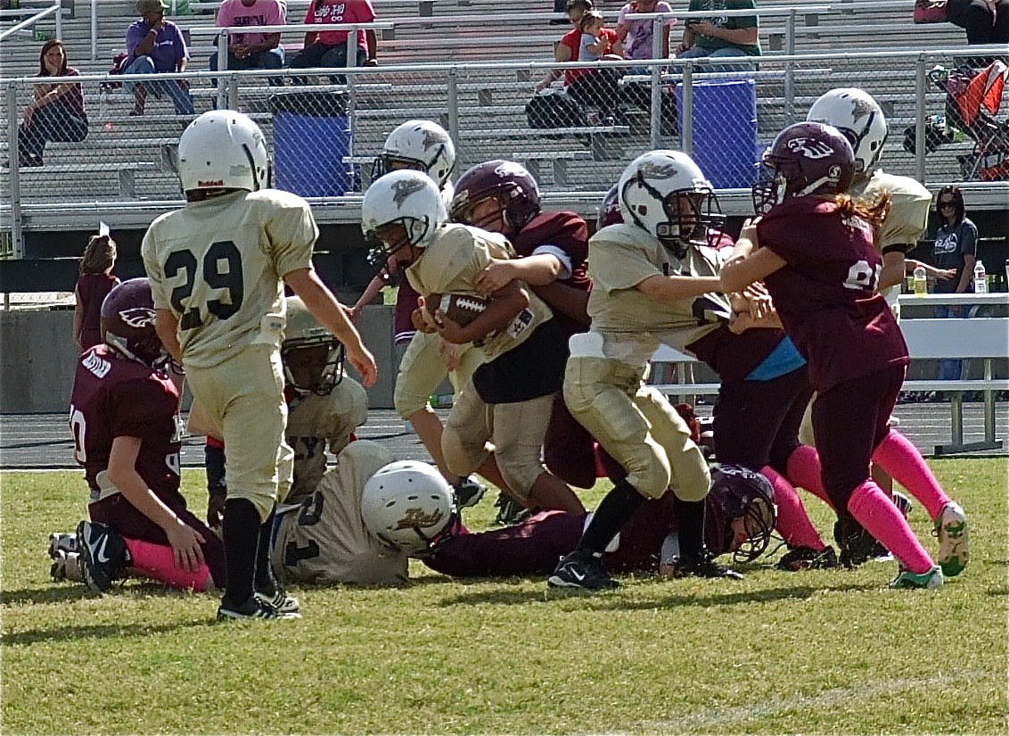 Image: IYAA B-Team’s Cornelius Jones(33) fights for more yards.