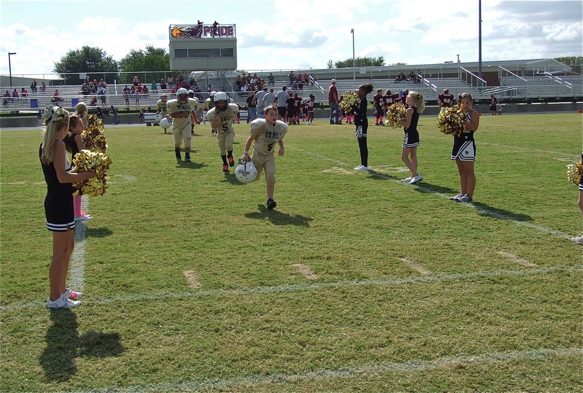 Image: Bryce DeBorde(4), Eric Martinez(5) and Nicholas Gomez(98) take their victory jog courtesy of the IYAA B-Team Cheerleaders.