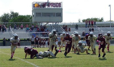 Image: A-Team quarterback Tylan Wallace(2) gets a block and then tries to get the corner.