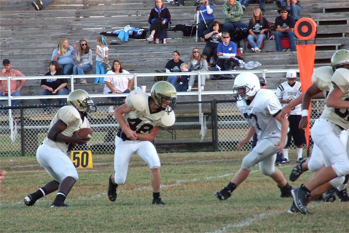 Image: Marvin Cox(10) fakes the handoff to Woods(48) and keeps around the left side of the Cougar defense.