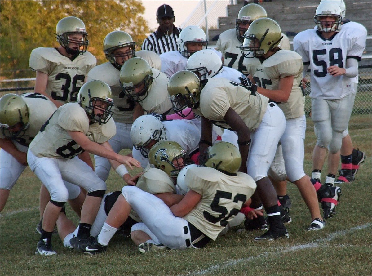 Image: Kelton Bales(75) and Bailey Walton(52) bring down a Leon runner.