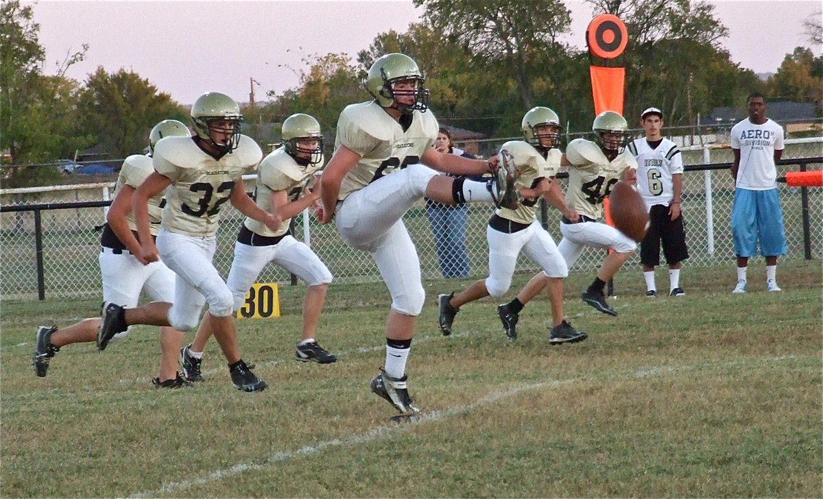 Image: Kyle Fortenberry(66) kicks off while Colin Newman(72), Cody Boyd(36), Chace McGinnis(85) and Justin Wood(48) give chase.