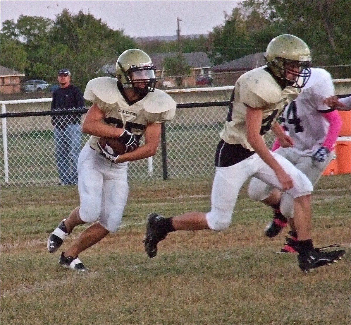 Image: Shad Newman(25) follows the lead block of Justin Wood(48) who punished unsuspecting Cougar defenders throughout the game.