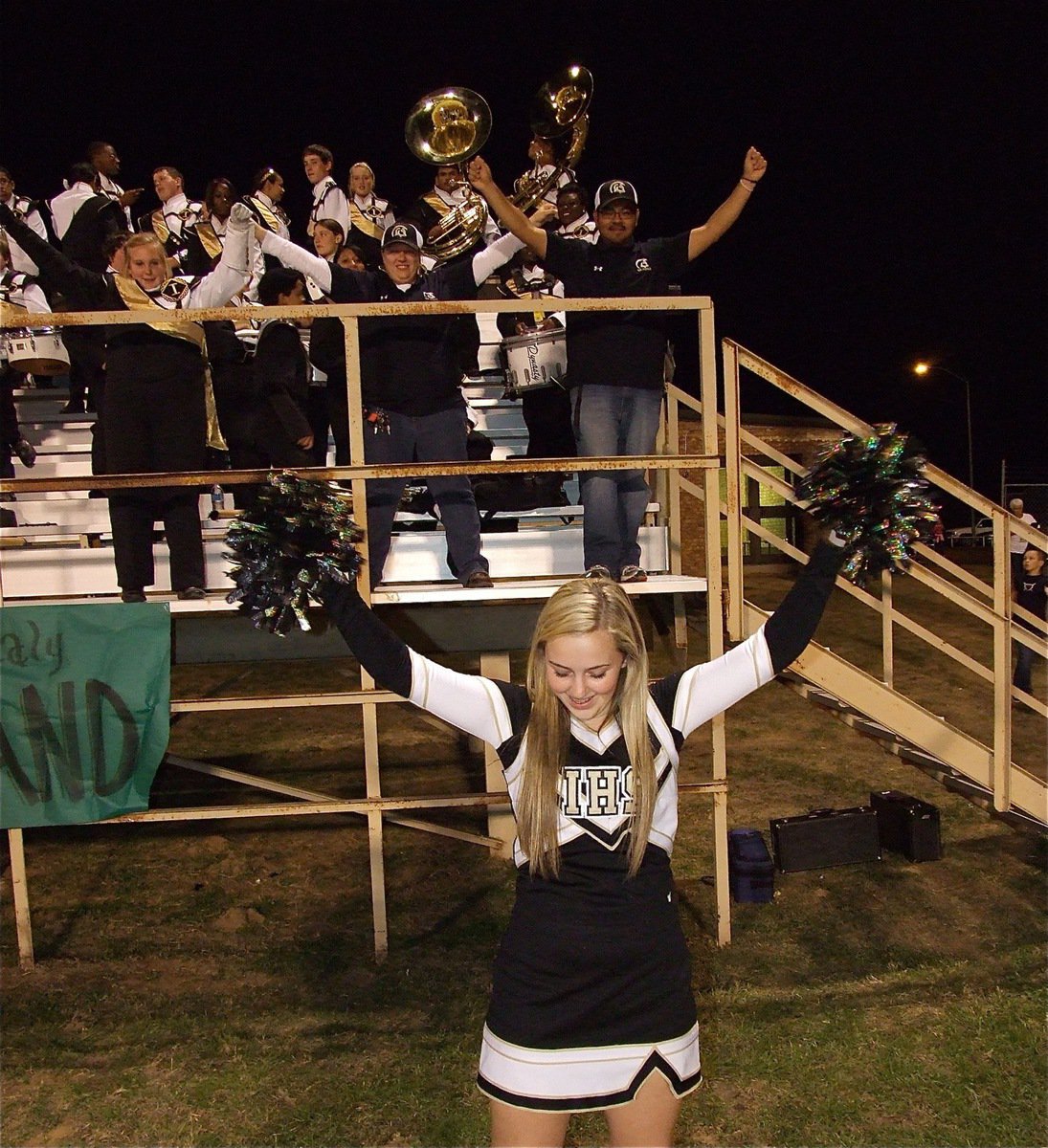 Image: Gladiator Regiment Marching Band higher-ups, Drenda Burk, Erica Scott and Jesus Perez mimic Kelsey Nelson as she practices her routine.