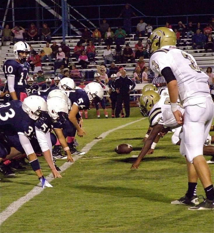 Image: On defense, Jase Holden(3), who is also the Gladiator quarterback, glares across Leon’s offensive line into the eyes of Cougar senior quarterback Kirby Watson(10).