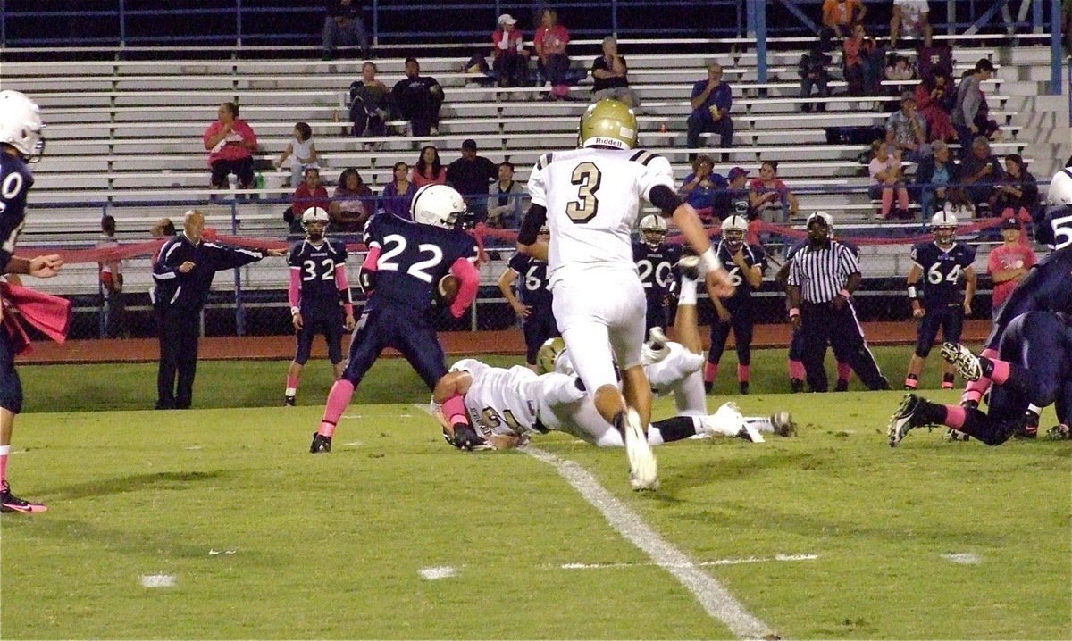 Image: Jase Holden(3) gives chase as Italy’s Chase Hamilton(2) latches onto a Cougar leg for the tackle behind the line of scrimmage.