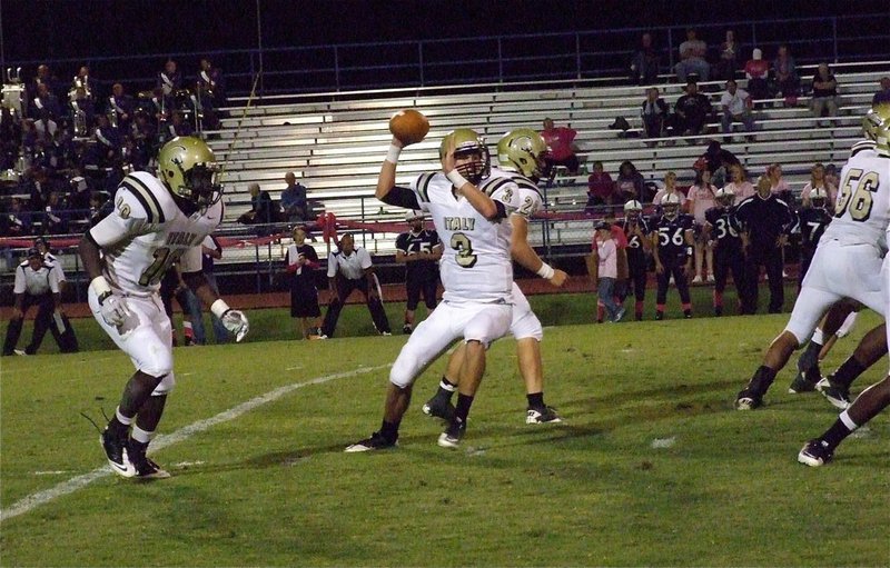 Image: Backs Ryheem Walker(10) and Kyle Jackson(28) help build a barrier around Jase Holden(3) who steps into a pass.