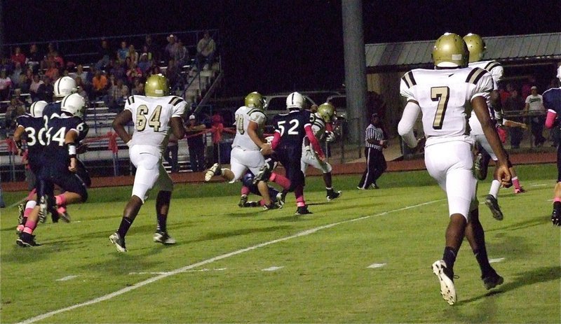 Image: Right offensive guard Isaac Medrano(70) helps Ryheem Walker(10) get extra yards against the Cougars as teammates Adrian Reed(64), Paul Harris(7) and Devonta Simmons(9) hustle over to assist.