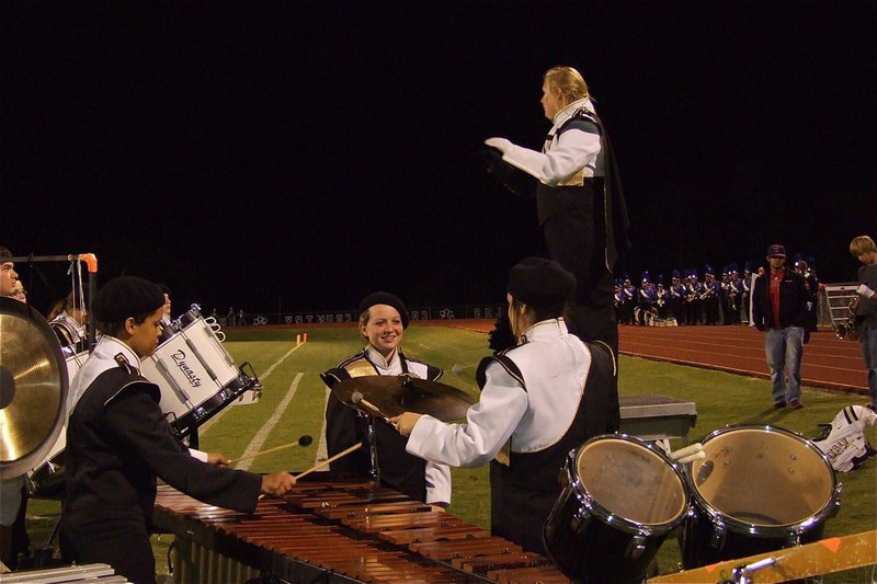 Image: Band major, Drenda Burk, guides the band’s performance from her pedestal as Kevin Roldan, Alex Minton, Maddie Pittman and Kaytlyn Bales make some noise.