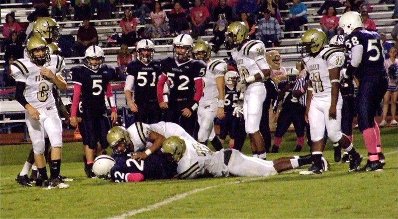 Image: Larry Mayberry, Jr.(77) and Omar Estrada(56) bring down a Cougar.