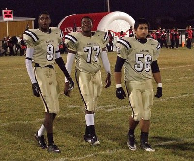Image: Gladiators Devonta Simmons(9), Larry Mayberry, Jr.(77) and Omar Estrada(56) take a moment before the game to join their senior classmates for the pre-game “Senior Night” introductions.