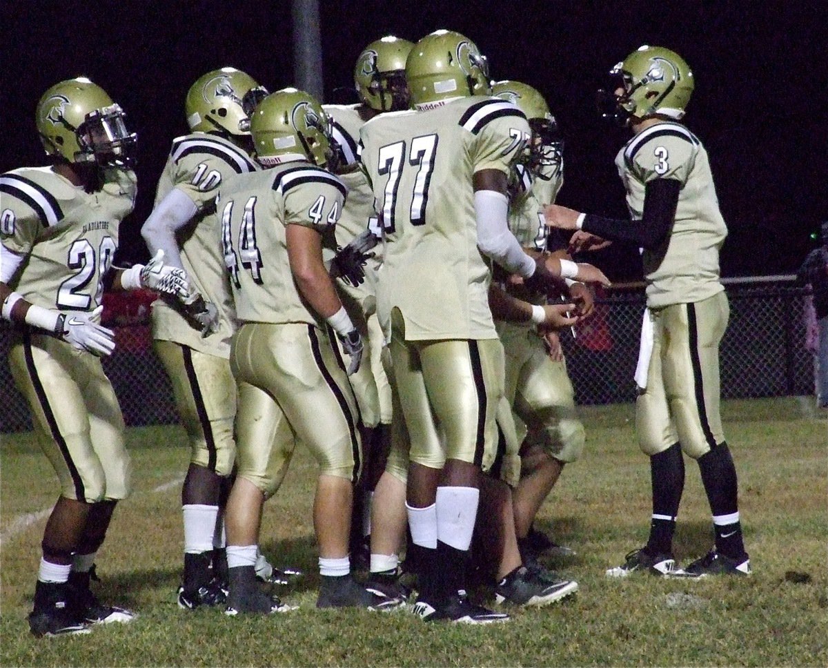 Image: Jase Holden(3) call the play and then the Gladiators break the huddle to start their first offensive possession against the Longhorns.