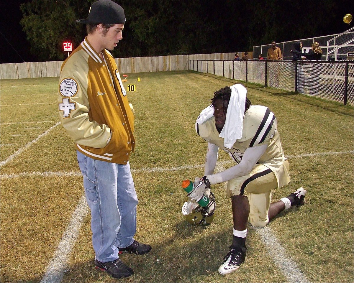 Image: Senior Brandon Souder(63) motivates junior Ryheem Walker during a break on the sideline. 