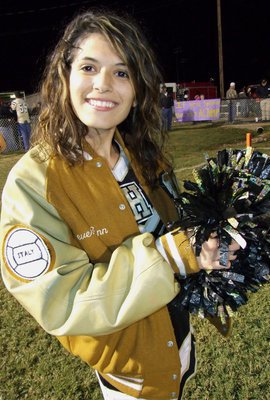 Image: Senior IHS cheerleader Beverly Barnhart is all smiles before Italy’s final home game of the 2011 season.