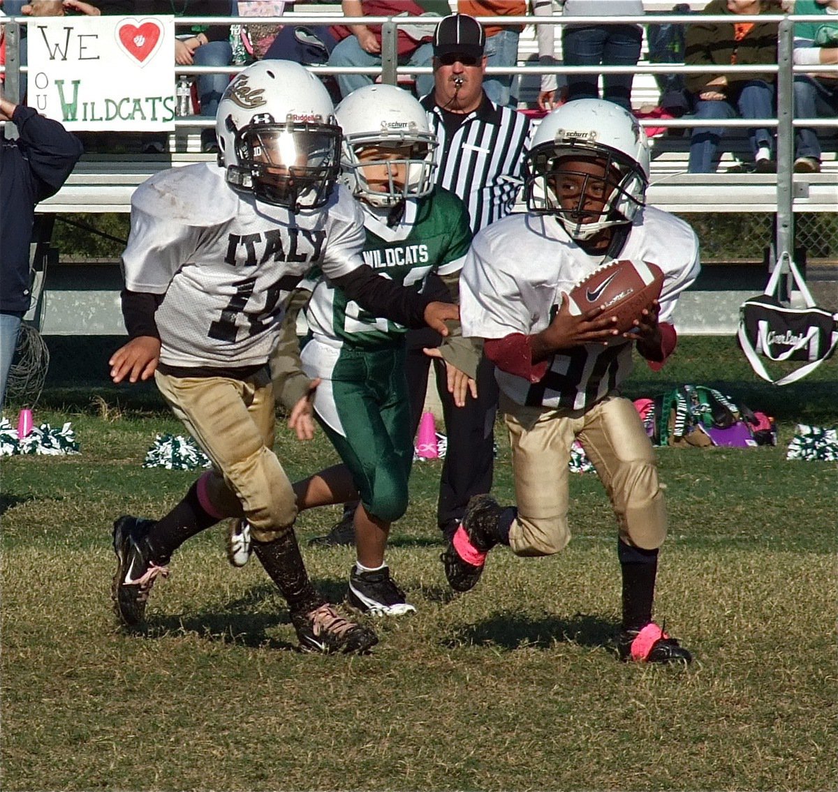 Image: IYAA C-Team quarterback, Laveranues Green(10), hands off to speedster, Darrin Jackson(80), who sprints around the left side of the Scurry Wildcat defense for the play-of-the-game.