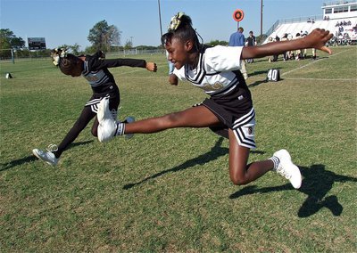 Image: IYAA B-Team cheerleaders Destiny Harris and Shaniaya Johnson gain altitude after their cheer.