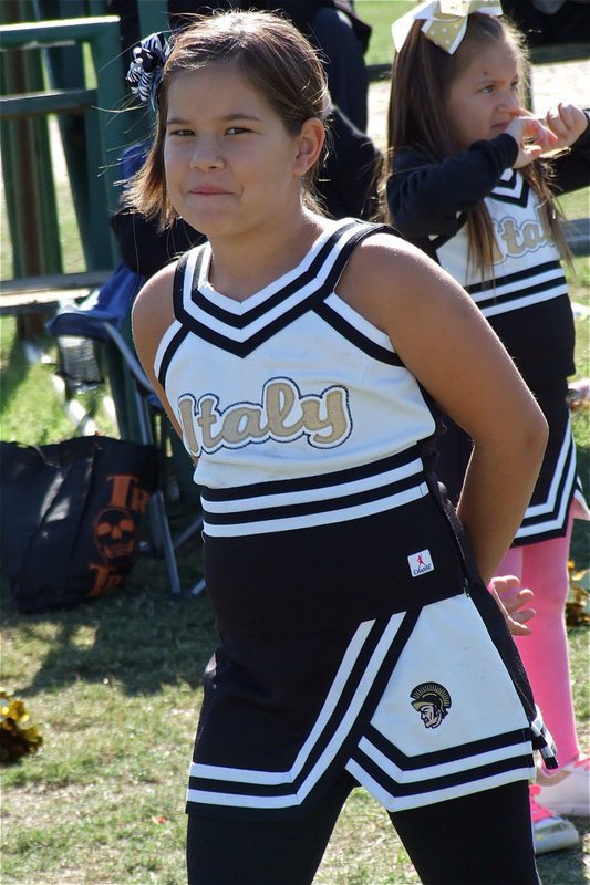 Image: IYAA B-Team cheerleader Nevaeh Salcido is unable to hold back a smile with her B-Team Gladiators leading on the scoreboard.