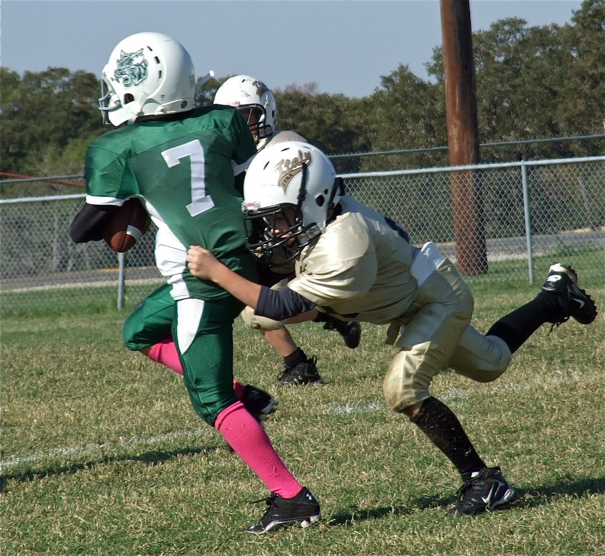 Image: IYAA B-Team Gladiator Preston Rasco(9) captures a Wildcat runner for a short gain.