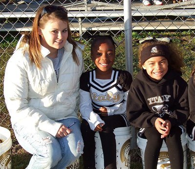 Image: C-team cheer coach, Jessica Posey, takes a break before the game with the C-team cheerleaders.