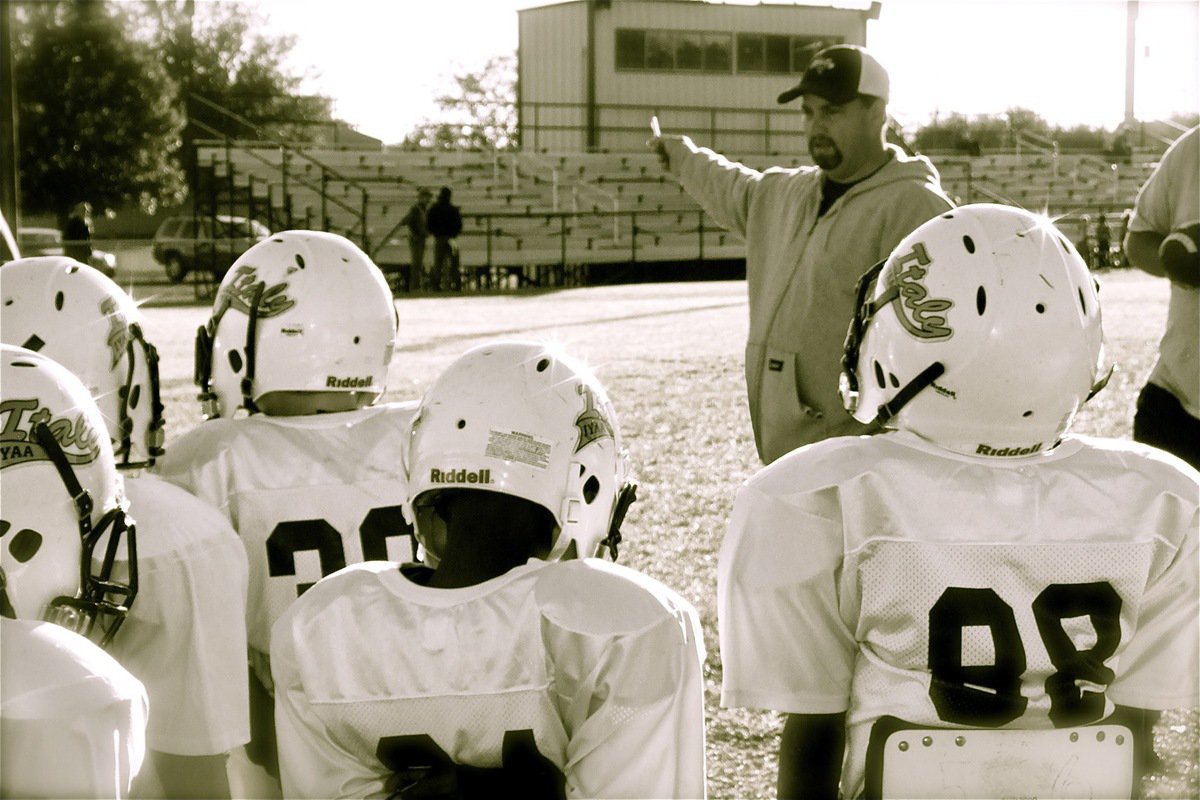 Image: C-Team assistant coach, Barry Byers, sets the course for a victory over the Bulldogs.