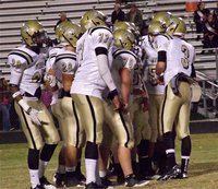 Image: Gladiator quarterback Jase Holden(3) huddles with his offensive unit during pre-game warmups.