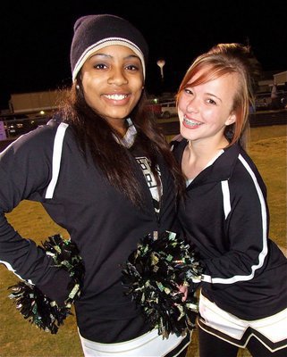 Image: IHS cheerleaders Ashley Harper and Felicia Little have fun before the game.