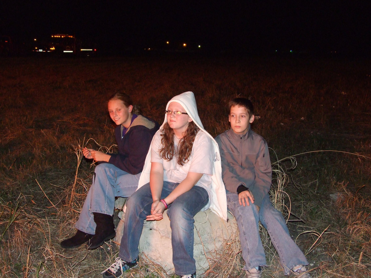 Image: Makenzie Davis, Smantha Owen and Volley Jaynes take in the sight of the fire.