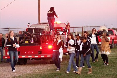 Image: The IHS Cheerleaders arrive in style, on the back of an Italy fire truck.