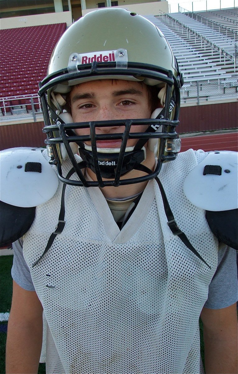 Image: Cornerback Hayden Woods gets geared up for practice.