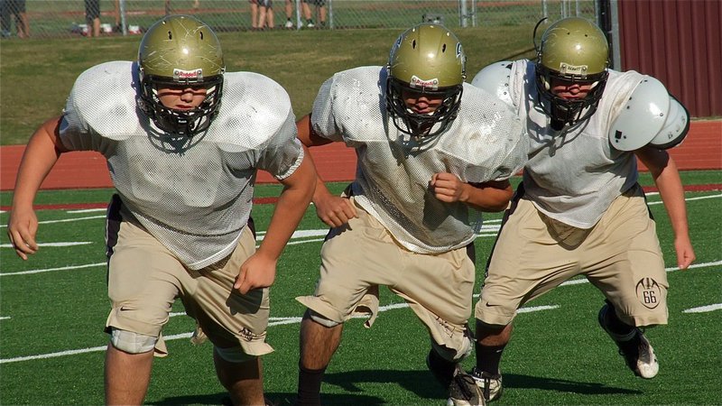 Image: Kelton Bales, Braulio Luna and Kyle Fortenberry fire off during line drills.
